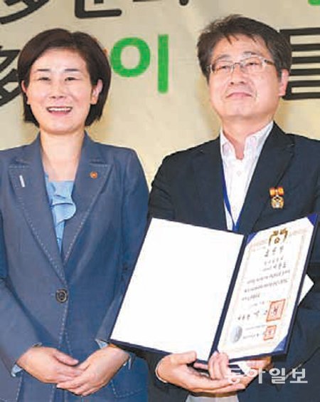 이광표 동아일보 정책사회부장(오른쪽)이 10일 김희정 장관으로부터 대통령표창을 받았다. 이훈구 기자 ufo@donga.com
