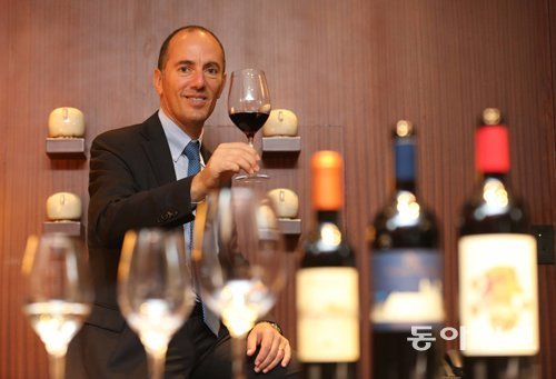 지난달 30일 돈나푸가타 와이너리의 안토니오 랄로 사장이 서울그랜드 하얏트 호텔에서 고급 와인인 ‘밀레 에 우나 노테’를 들고 웃고 있다. 김미옥 기자 salt@donga.com
