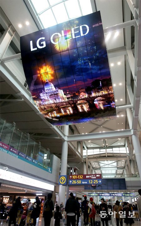 올해 11월 인천국제공항 여객터미널 천장에 설치된 초대형 OLED 디스플레이 광고판 모습. LG전자는 55인치 크기의 곡면 OLED 디스플레이를 140장 이어 붙여 가로 8m, 세로 13m 크기로 만들었다. 동아일보DB