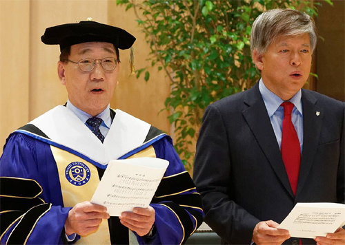 김용학 연세대 신임 총장(왼쪽)이 1일 취임식에서 염재호 고려대 총장과 찬송가를 부르고 있다. 연세대 제공