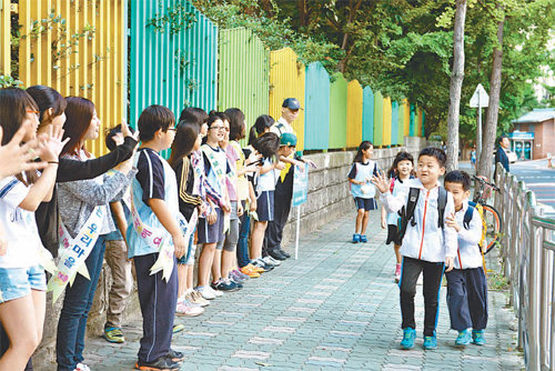 대구 달서구 송일초교 학생들이 교문 앞에서 월성1동 교육나눔의 하나인 등교 인사 캠페인을 벌이고 있다. 대구 달서구 제공