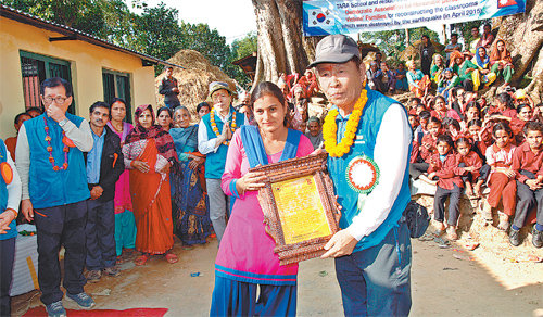 지난해 11월 정춘식 5·18민주유공자유족회장이 네팔 타라학교 관계자로부터 학교 재건에 감사하다는 내용이 담긴 감사패를 받고 있다. 5·18민주유공자유족회 제공