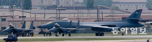 한국에 처음 착륙한 B-1B ‘랜서’ 21일 경기 평택시 오산비행장에 착륙한 미 공군의 전략폭격기 
B-1B 랜서가 미 공군 관계자들의 점검을 받고 있다. B-52, B-2와 함께 ‘전략폭격기 삼총사’로 불리는 B-1B는 한반도 
유사시 가장 먼저 출동해 북한 지휘부와 핵심시설을 정밀 타격할 핵우산 자산이다. B-1B는 2000파운드(약 900kg)급 
합동정밀직격탄(JDAM) 24발이나 500파운드(약 226kg)급 비유도 재래식 폭탄 84발을 적재한다. 핵탄두 탑재 공대지 
정밀유도폭탄도 20∼30발 탑재할 수 있다. 평택=원대연 기자 yeon72@donga.com