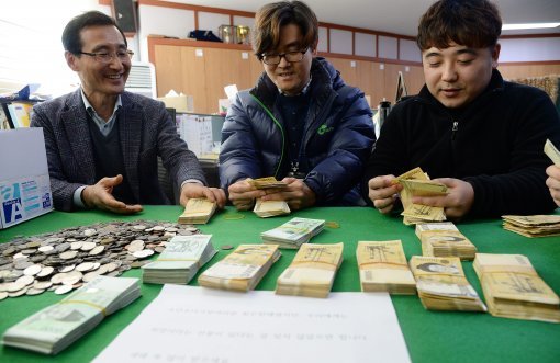 28일 전북 전주시 노송동 주민센터에서 직원들이 ‘얼굴 없는 천사’가 맡긴 돈을 세고 있다. 얼굴 없는 천사는 2000년부터 올해까지 4억9785만9600원을 기부했다.