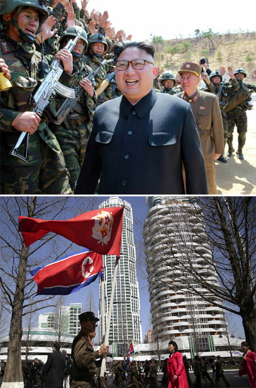 안으론 전쟁 훈련… 밖으론 신시가지 홍보 김정은 북한 노동당 위원장(가운데)이 ‘특수작전부대 강하 및 
대상물 타격 경기대회’에 참석했다고 노동신문이 13일 보도했다. 김 위원장이 행사에서 북한군의 환호를 받고 있다(위쪽 사진). 
북한의 최신식 거주지역인 평양 여명거리의 준공식이 13일 열린 가운데 행사에 참석한 북한군이 인공기를 들고 여명거리를 걷고 
있다(아래쪽 사진). 노동신문·평양=AP 뉴시스