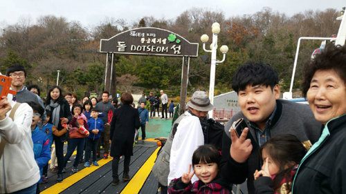 경남 창원시 마산만의 돝섬 해상관광지를 찾은 개그맨 김수영 씨(오른쪽에서 두번째)가 관광객들과 즐거운 시간을 보내고 있다. 돝섬해피랜드 제공