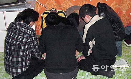 북한 지하교회 교인들의 기도 모습으로 알려진 사진. 하지만 이들이 진짜 북한 지하교인들인지, 촬영 장소가 북한이 맞는지는 확실치 않다. 북한에서 종교 활동이 발각되면 사형을 피하기 어렵다. 동아일보DB