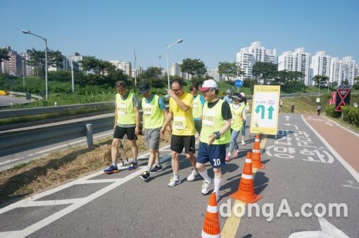 지체장애인의 서포터로 마라톤 대회에 동참한 고려사이버대 김진성 총장(앞줄 왼쪽에서 네번째)이 선수들을 격려하고 있다. 사진제공=고려사이버대학교