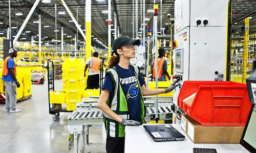 미국 뉴저지주에 있는 아마존 공장에서 한 직원이 로봇이 잘 작동하는지 지켜보고 있다. 로봇을 다루는 기술이 중요해지는 시대다. 뉴욕타임스 홈페이지 캡처