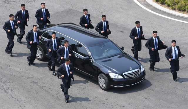 경호원 12명, 벤츠 에워싸고 함께 달려 김정은 북한 국무위원장이 탑승한 차량이 27일 판문점 평화의집을 출발해 북측으로 되돌아가자 경호원 12명이 뛰어가면서 경호하고 있다. 판문점=한국사진공동취재단