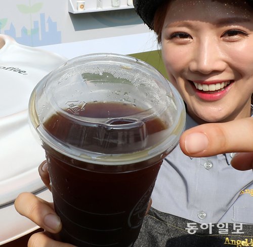8일 서울 종로구 엔제리너스 세종로TO점에서 직원이 13일부터 새로 적용되는 컵 뚜껑(리드)을 선보이고 있다. 전영한 기자 scoopjyh@donga.com
