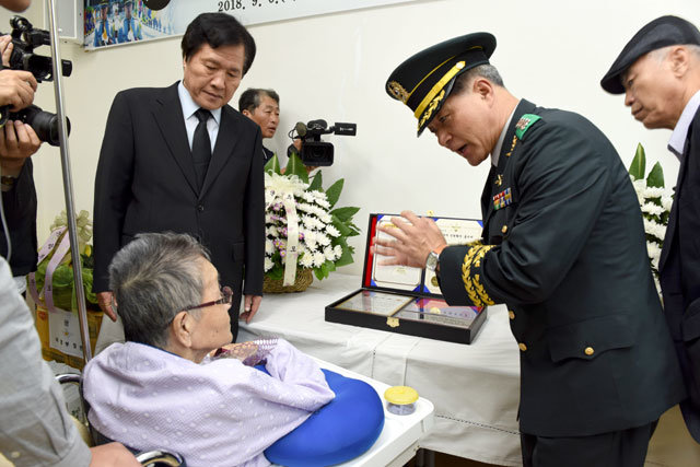 국방부 유해발굴감식단 관계자가 6일 경남 통영에서 열린 ‘호국의 영웅 귀환행사’에서 6·25전쟁에서 전사한 김정권 이등중사의 유골 신원 확인 과정을 아내 이명희 씨(앞줄 왼쪽) 등 유가족에게 설명하고있다. 국방부 제공