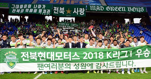 7일 울산문수경기장에서 통산 6번째 K리그1 우승을 달성한 전북현대 선수단이 대형 현수막을 들고 팬들에게 기쁨을 전하고 있다. 2009·2011·2014·2015·2017 시즌에 이은 6번째 리그 정상등극이자 최근 두 시즌 연속 우승이다. 울산｜김민성 기자 marineboy@donga.com