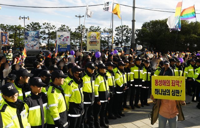 13일 부산 해운대구 구남로 인근에서 열린 ‘제2회 부산퀴어문화축제’ 퍼레이드 행렬 옆에서 동성애를 반대하는 종교인들이 집회를 열고 있다. 2018.10.13/뉴스1