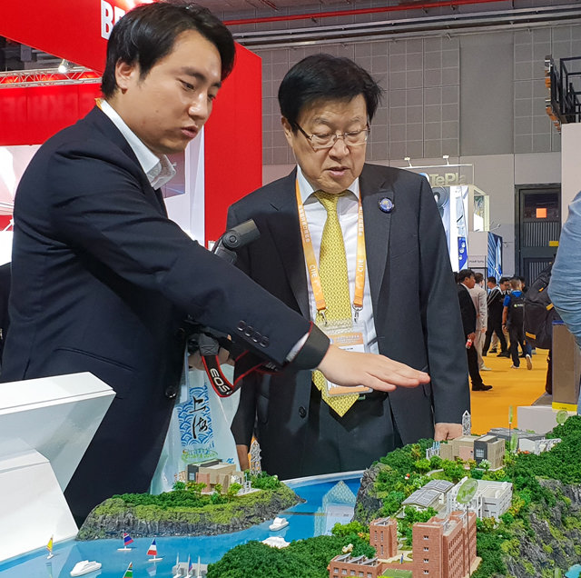 김영주 무협회장 박람회 시찰 6일 김영주 한국무역협회장(오른쪽)이 중국 상하이에서 열린 ‘제1회 중국 국제수입박람회’ 내 LS그룹 부스에서 신재생에너지와 에너지관리시스템을 결합한 친환경 섬 모형을 둘러보고 있다. 한국무역협회 제공