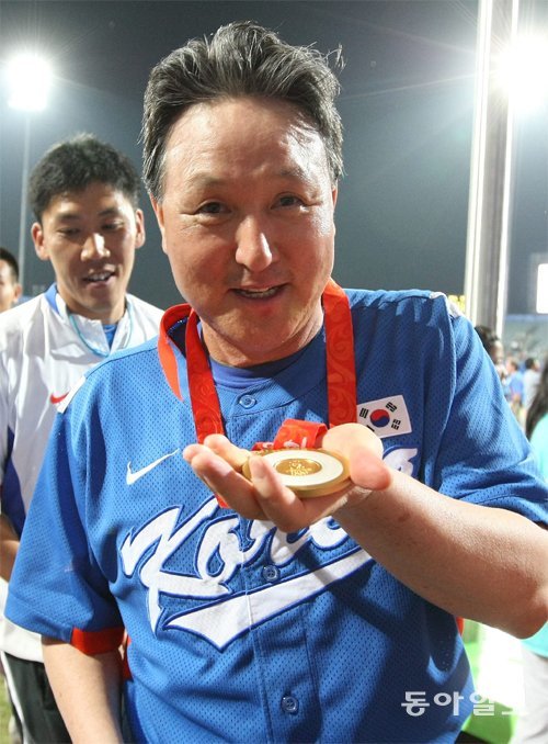 2008 베이징 올림픽에서 우승을 확정 지은 직후 금메달을 들어 보이며 활짝 웃고 있는 김경문 감독. 동아일보DB