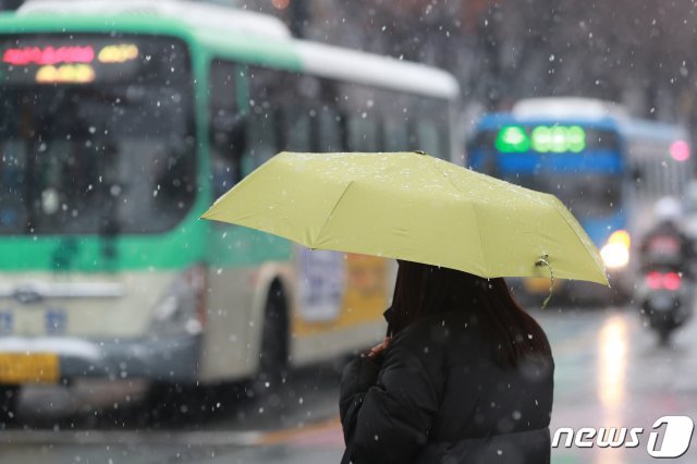 31일 대구 도심에 눈이 내리자 우산을 쓴 시민들이 발걸음을 재촉하고 있다. 대구기상지청은 “중국 북부지방에서 남하하는 고기압의 영향을 받아 대구·경북에 오후까지 비나 눈이 내릴 것”으로 예보했다. © News1
