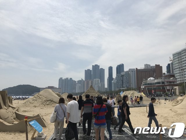 해운대해수욕장 개장일인 1일 백사장을 찾은 시민들이 모래축제 작품들을 둘러보고 있다.2019.06.01© 뉴스1