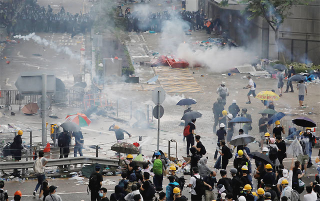 ‘제2 우산혁명’ 치닫나 12일 홍콩 경찰이 ‘범죄인 인도 법안’ 반대 시위대를 향해 발사한 최루가스와
 고무탄으로 거리 곳곳에서 흰색 연기가 피어오르고 있다. 홍콩 정부는 시위가 확산되자 이날 오후 시위를 폭동으로 규정하고 무력 
진압에 들어갔다. 홍콩=AP 뉴시스