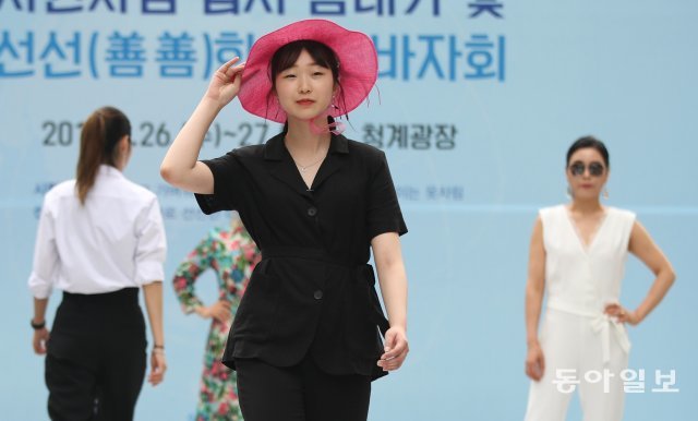 블랙의상에 핑크 모자를 쓴 시민모델