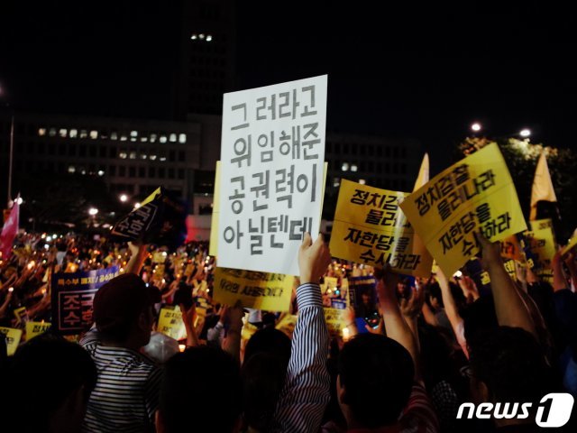 28일 오후 서울 서초구 대검찰청 앞에서 열린 검찰개혁·사법적폐 청산 집회에서 사법적폐청산 범국민시민연대 등 참가자들이 검찰을 향해 ‘그러라고 위임해준 공권력이 아닐텐데’라고 적힌 피켓을 들고 있다. 2019.9.28/뉴스1 ⓒ News1