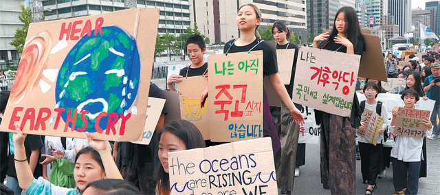 지난달 27일 서울 종로구 세종로 공원에서 청소년 기후 행동 소속 학생들이 결석 시위에 참석한 모습. “나는 기후악당 국민이고 싶지 않습니다” 등의 팻말을 걸고 학생들이 행진하고 있다. 동아일보DB