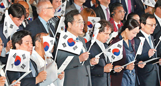 이낙연 국무총리(앞줄 왼쪽에서 세 번째)가 3일 오전 서울 세종문화회관에서 열린 제4351주년 개천절 경축식에서 참석자들과 함께 태극기를 흔들며 개천절 노래를 부르고 있다. 뉴시스