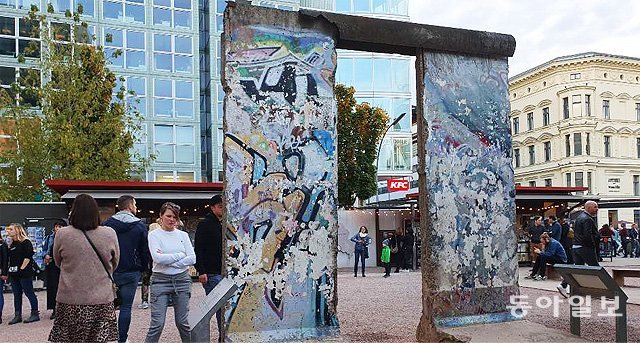 동서 베를린 왕래 검문소였던 ‘체크 포인트 찰리’ 인근에 전시된 베를린 장벽을 사람들이 유심히 살펴보고 있다. 다음 달 9일 장벽 붕괴 30주년을 맞아 베를린 도심에서는 각종 행사와 전시가 열리고 있다. 베를린=김윤종 특파원 zozo@donga.com