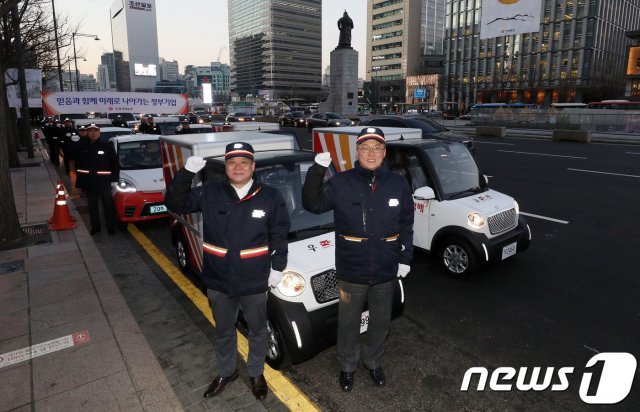 집배원들이 서울 광화문 교보빌딩 앞에서 ‘2019 희망배달 집배원 안전다짐 전기차 퍼레이드’ 출발 전 기념촬영을 하고 있다.  © News1