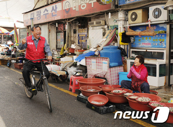 제20대 국회의원 선거 때 전남 순천시에서 당선된 새누리당 이정현 후보가 14일 오전 전남 순천시 덕암동 역전시장에서 자전거를 타며 시민들에게 당선인사를 하고 있다. 2016.4.14/뉴스1 © News1