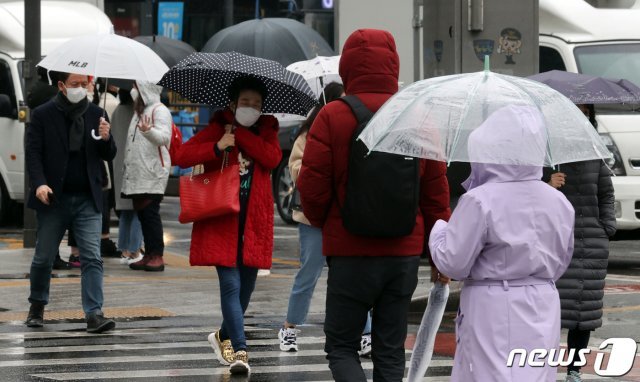 28일 오후 서울 광화문광장에서 우산을 쓴 시민들이 발걸음을 재촉하고 있다. 2020.2.28/뉴스1 © News1