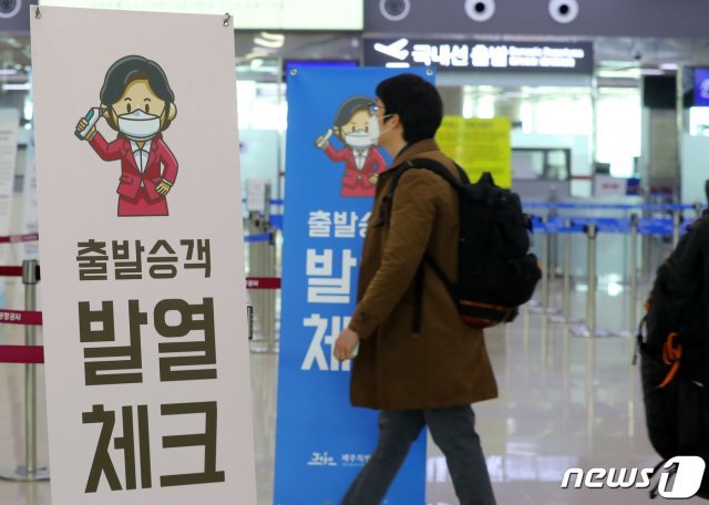24일 오후 제주국제공항 국내선 탑승장에서 관계자들이 열화상 카메라로 이용객들의 체온을 체크하고 있다. 제주도는 신종 코로나바이러스 감염증(코로나19) 확산 방지를 위해 이날부터 국내선 출발장에 열화상 카메라를 설치해 운용한다.2020.3.24/뉴스1 © News1