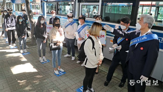 11일 부산지하철 2호선 동의대역 출구 앞에서 공순진 동의대 총장(오른쪽)과 대학 홍보대사인 학생들이 학생들을 대상으로 발열 검사를 실시했다. 부산=박경모 기자 momo@donga.com