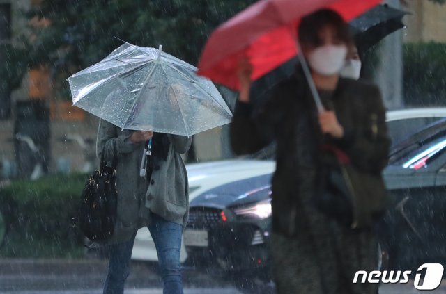 18일 오후 서울 광화문네거리에서 시민들이 갑자기 내린 폭우에 발걸음을 옮기고 있다. 2020.5.18/뉴스1 © News1