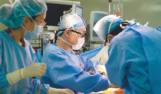 송 교수는 의사의 숙명이라며 “환자가 생존하면 보상을 받는 느낌”이라고 말했다. 아래 사진은 송기원 교수(가운데)가 간이식 수술을 하고 있는 모습. 서울아산병원 제공