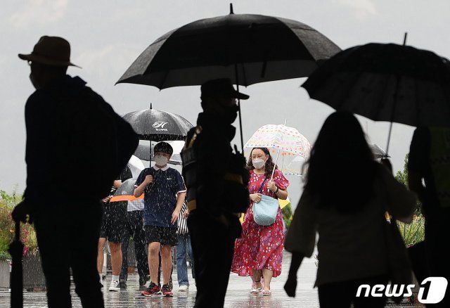비가 내린 23일 오후 광화문광장 일대에서 우산을 쓴 시민들이 발걸음을 재촉하고 있다. 2020.7.23/뉴스1 © News1