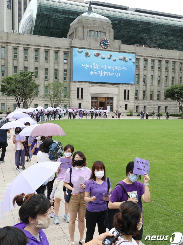 박원순 전 서울시장 성추행 피해자 측 관계자들이 28일 오전 서울광장에서 박원순 전 서울시장 위력에 의한 성폭력 사건의 국가인권위원회 직권 조사를 촉구하며 보랏빛 옷을 입고 행진하고 있다. 2020.7.28/뉴스1