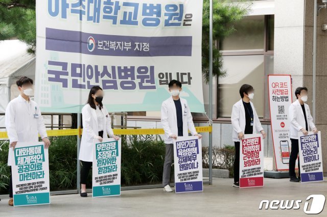 의과대학 정원 확대 등 정부의 의료정책에 반대하는 인턴·레지던트 등 전공의들이 순차적 집단휴진에 들어간 21일 오후 경기도 수원시 아주대학교 병원에서 의료진들이 피켓을 들고 서 있다. 2020.8.21/뉴스1 © News1