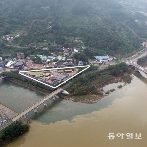 경남 하동의 섬진강(오른쪽)으로 지류인 화개천이 직각을 이루며 합류하고 있다. 사진 위쪽이 하류 방향이다. 지난달 집중호우에 섬진강으로 화개천 물이 빠져나가지 못하고 오히려 역류하면서 합류 지점에 있는 화개장터(삼각형 실선 부분)가 지붕까지 침수됐다. 하동=양회성 기자 yohan@donga.com