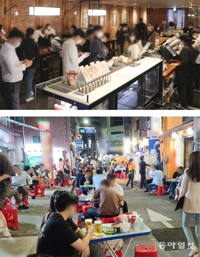 활기 되찾은 카페-호프집 수도권의 사회적 거리 두기가 2단계로 하향된 14일 서울 중구의 한 프랜차이즈 커피전문점 매장에 음료를 주문하려는 손님들이 줄을 서 있다(위쪽 사진). 같은 날 오후 9시경 서울 중구 지하철 2호선 을지로3가역 인근 ‘노가리 골목’에는 수백 명의 시민이 몰려들어 술을 마시고 있다. 홍진환 jean@donga.com·박영대 기자