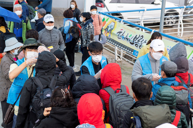 16일 경북 울릉군 울릉읍 저동항에서 관광객들이 체온 검사를 받고 있다. 강릉에서 출발한 이들은 2중 방역 체계를 통과한 뒤 울릉도에 내렸다. 울릉군 제공