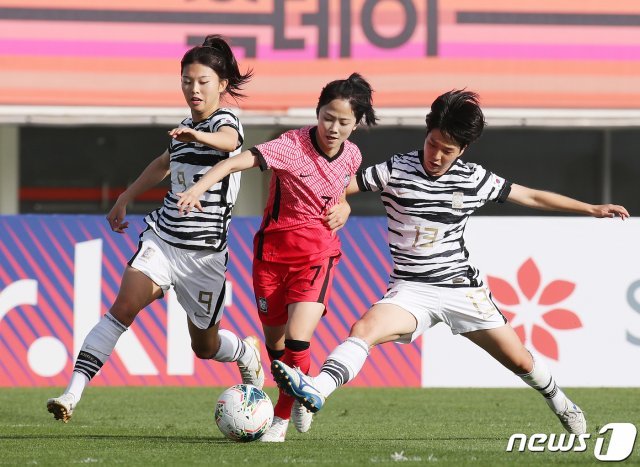 22일 오후 경기도 파주시 파주스타디움에서 열린 ‘신세계 이마트 후원 여자축구국가대표팀 스페셜매치’ 여자 국가대표팀과 여자 U-20대표팀의 경기에서 국가대표팀 이민아가 U-20 대표팀 이민정, 박혜정(오른쪽)의 마크를 따돌리고 있다. 2020.10.22/뉴스1 © News1