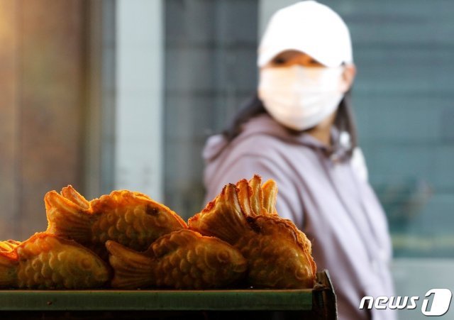 3일 오후 명동 거리에서 한 시민이 붕어빵에 시선을 고정한 채 지나가고 있다. 2020.11.3 © News1