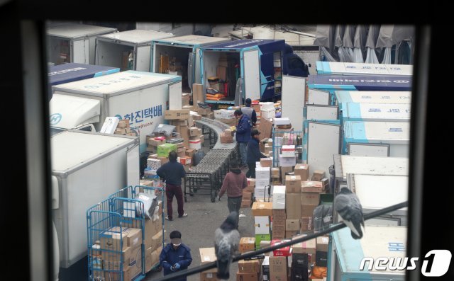 지난달 13일 서울 시내의 한 택배 물류센터에서 기사들이 배송 준비를 하고 있다. 2020.11.13/뉴스1 © News1