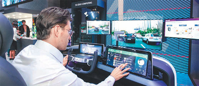 SK텔레콤이 올해 초 세계 최대 정보기술(IT)·가전 전시회 ‘CES 2020’에서 공개한 차량용 인포테인먼트 시스템을 관람객이 체험하고 있다. SK텔레콤 제공