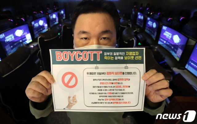 정부의 거리두기 2.5단계 연장안이 발표된 18일 서울의 한 PC방에서 관계자가 영업을 종료 해야만 하는 저녁 9시가 되자 불은 켜두고 영업은 하지 않는 ‘점등시위’를 하고 있다. 한국인터넷콘텐츠서비스협동조합 소속 PC방 업주들은 이날부터 영업제한에 항의하는 의미로 오후 9시 이후 점등시위를 이어나갈 예정이다. 2021.1.18/뉴스1 © News1