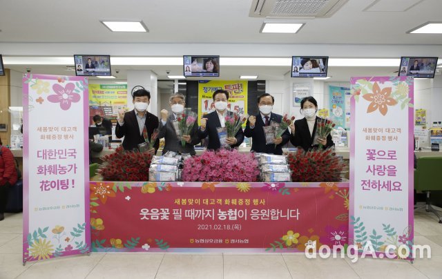 이재식 농협상호금융 대표(가운데)가 18일 서울 양천구 경서농협 본점에서 열린 새봄맞이 대고객 화훼증정 행사에서 이철환 
경서농협조합장(왼쪽부터 네번째), 이대엽 농협 서울지역본부장(두번째)과 함께 기념촬영을 하고 있다. 농협 제공