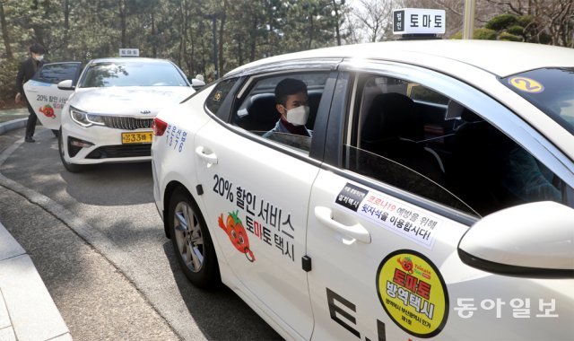 22일 부산 사상구 신라대 백양생활관 앞에서 코로나19 확진자 전용 ‘토마토 방역택시’가 자가격리 중인 외국인 학생을 태우고 있다. 부산 지역 플랫폼 택시인 ‘토마토 택시’가 전국에서 처음으로 코로나19 확진자 및 자가격리자 전담 택시를 운행해 코로나 의심환자들이 이동하는 데 불편을 덜 것으로 보인다. 박경모 기자 momo@donga.com