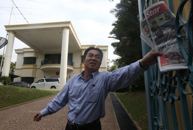 말레이시아 쿠알라룸푸르의 북한대사관에 김유성 참사가 정문에 나와 배달된 신문을 가져가고 있다. 2017년 2월 24일.