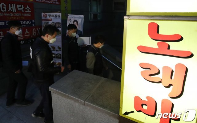 서울시청과 경찰, 질병관리청 수도권 질병대응센터 담당자가 5일 오후 서울 강남구 역삼동의 한 유흥업소로 유흥시설 방역수칙 등을 점검하기 위해 들어가고 있다. 7개팀 23명이 투입된 점검반은 이날 역삼동 일대 유흥업소를 방문해 마스크 착용 여부와 QR코드 의무화, 환기대장, 소독대장, 종사자 건강대장 관리 상태 등을 점검했다. 2021.4.5/뉴스1 © News1